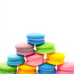 colorful stack of french macarons on white background
