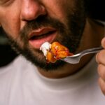 man eating delicious food close up